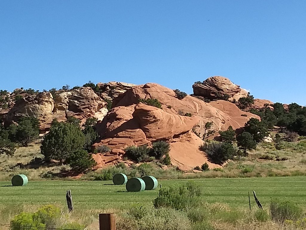 Breathtaking scenery such as this is quite common. Alfalfa field amongst the towering rocks.